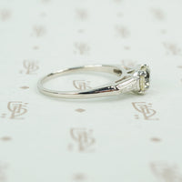 cushion cut yellow sapphire set in platinum with baguette diamond sides