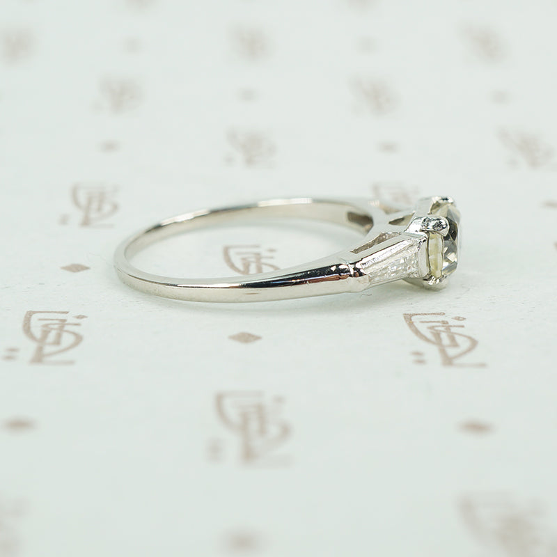 cushion cut yellow sapphire set in platinum with baguette diamond sides
