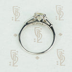 cushion cut yellow sapphire engagement ring set in platinum with baguette diamond sides