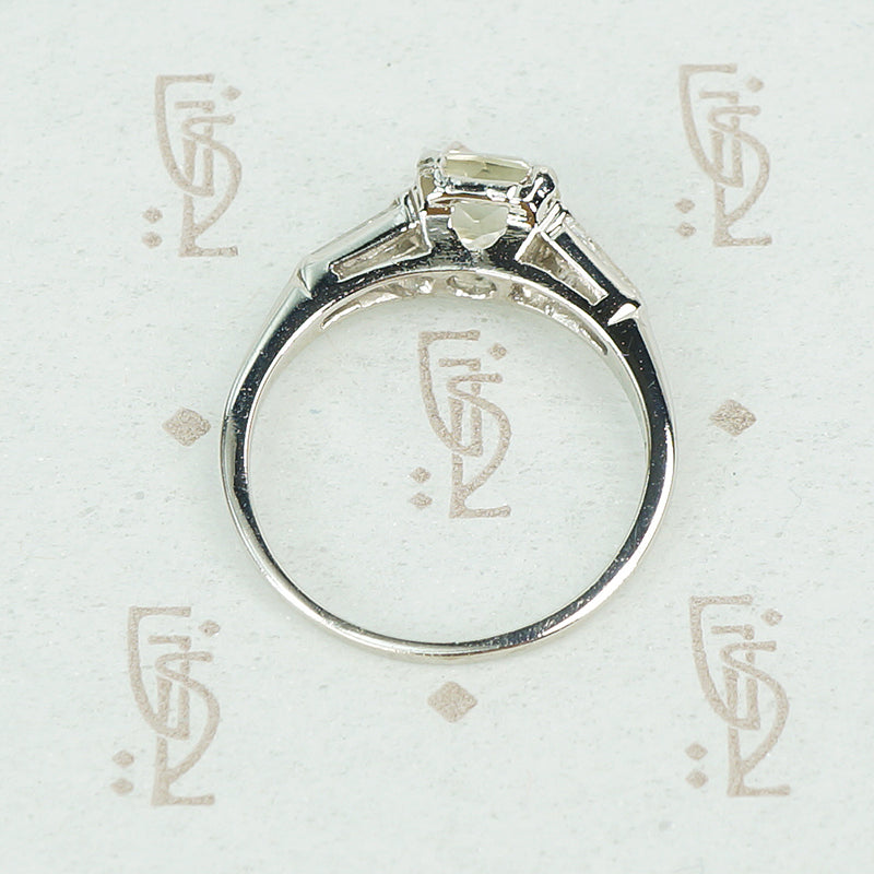 cushion cut yellow sapphire engagement ring set in platinum with baguette diamond sides