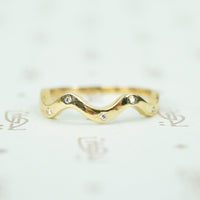14k recycled yellow gold wave band with 5 flush set tiny round diamonds