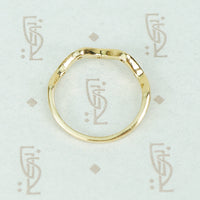 top side view of 14k recycled gold wave diamond band