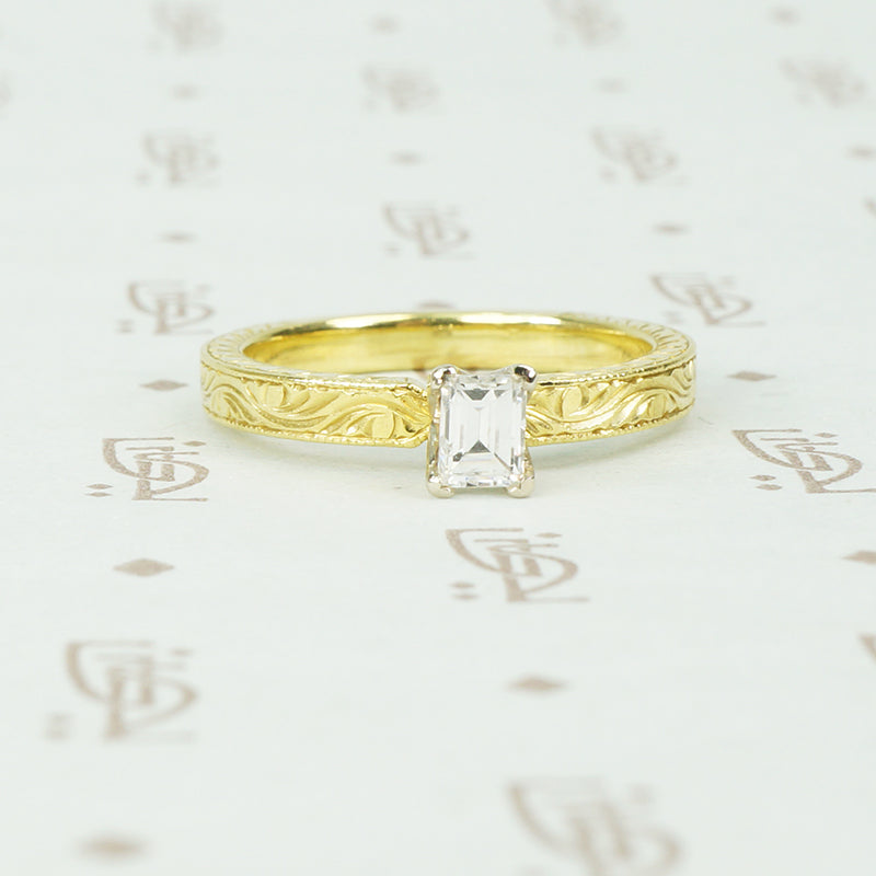 18k yellow gold and emerald cut diamond engagement ring