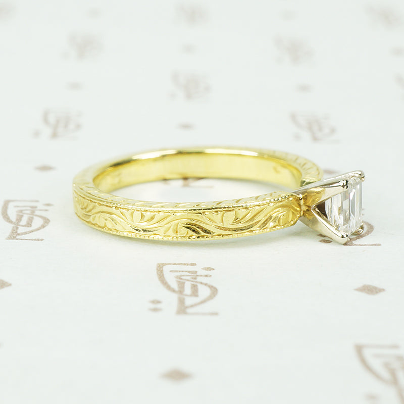 18k yellow gold and emerald cut diamond engagement ring