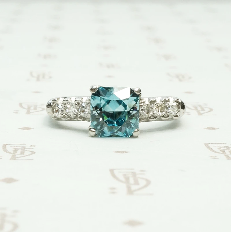 french cut natural blue zircon in platinum with round white side diamonds circa 1940's 