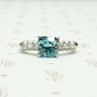 french cut natural blue zircon in platinum with round white side diamonds circa 1940's 